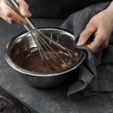 high-angle-pastry-chef-preparing-chocolate-cake