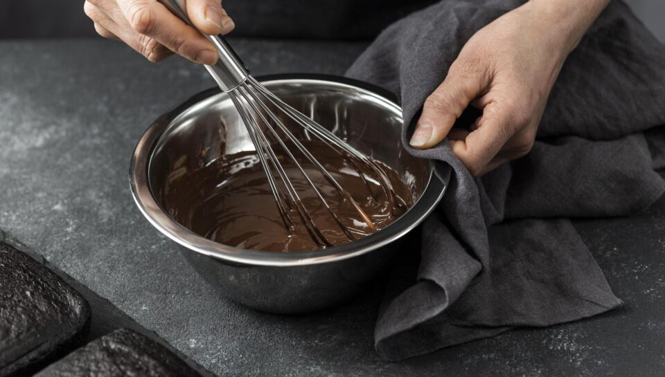 high-angle-pastry-chef-preparing-chocolate-cake